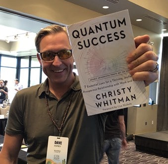 NY Times Bestselling Author Dave Asprey Holding copy of Quantum Success by Christy Whitman